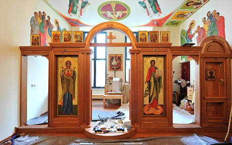 Colourful mural and ceiling paintings together with an ornate wooden iconostasis adorn the new church 
